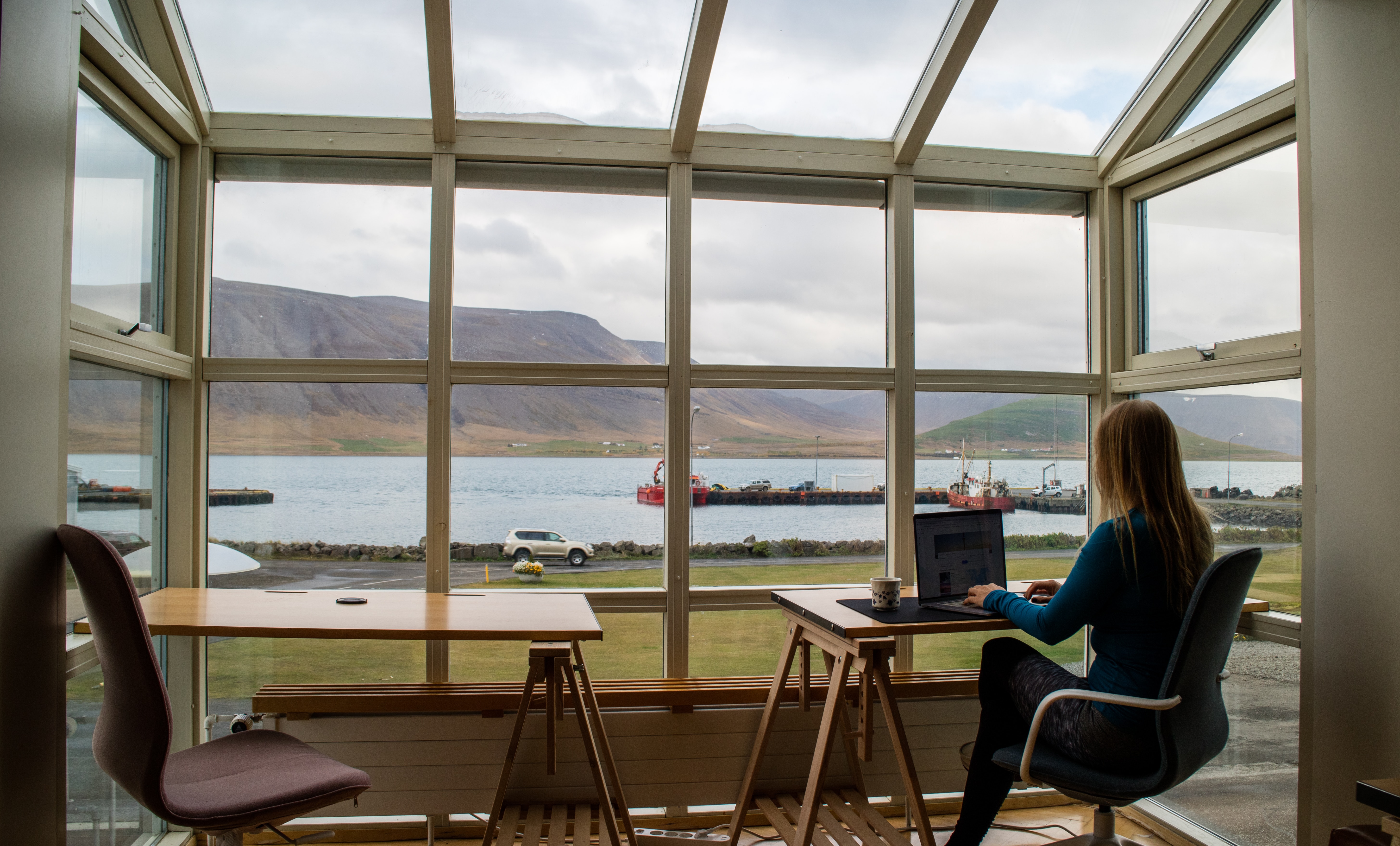Remote worker using a laptop computer in a scenic work space.